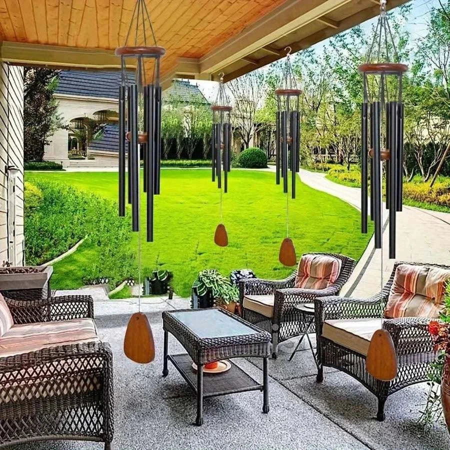 Classic black aluminum wind chimes with wooden tag hanging in outdoor garden decor